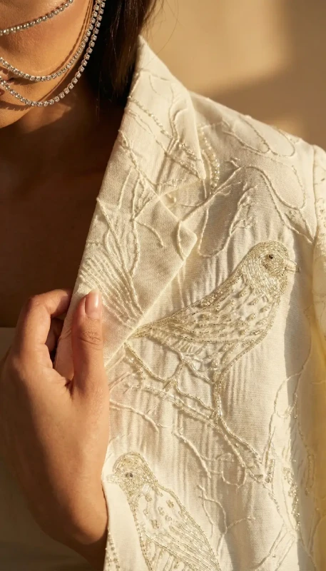 Side profile of Finch long ivory embroidered kimono styled in Dubai